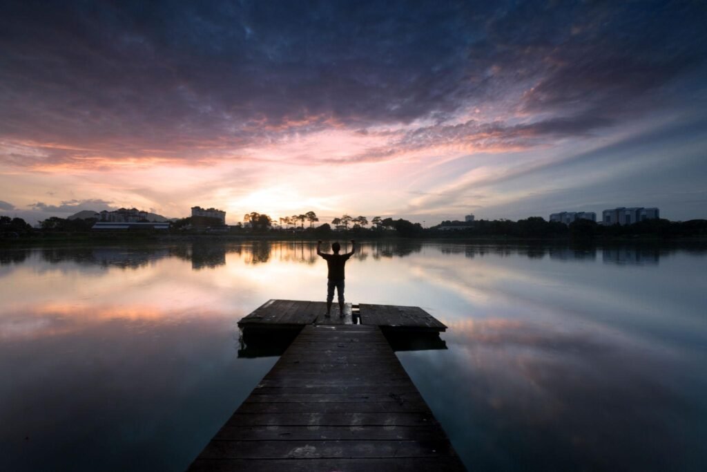“Person walking toward sunlight symbolizing a self growth journey and personal transformation.”